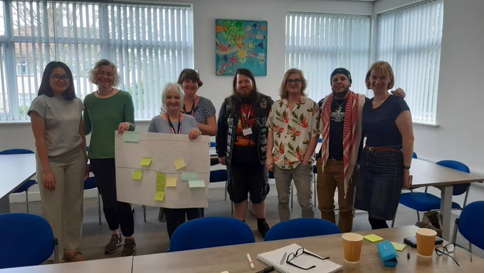 A group of people gathered together to present some work
