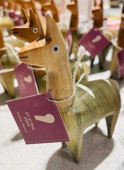 picture of a wooden llama with the csv,conf,v8 logo
