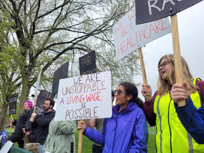 Workers at Dartmouth hold picket signs