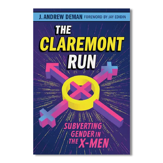 Alt text: Cover of a book titled "The Claremont Run" with the subtitle "Subverting Gender in the X-Men," authored by J. Andrew Deman with a foreword by Jay Edidin. The cover design features an iconic X-Men belt buckle in gold at the center, surrounded by colorful background rays and various X-Men symbols in pink, blue, and white.