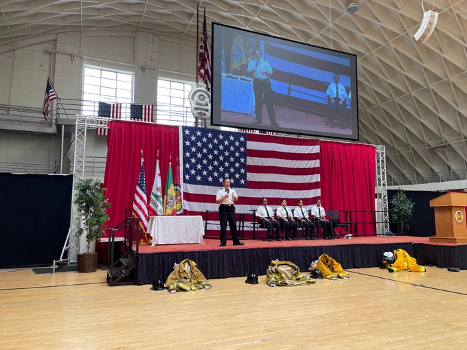 Chief Crowley standing on a stage/platform speaking at the graduation