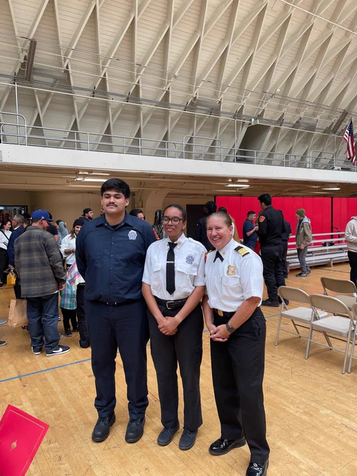 Chief Crowley standing with 2 students inside Frank Hotchkin Memorial Training Center
