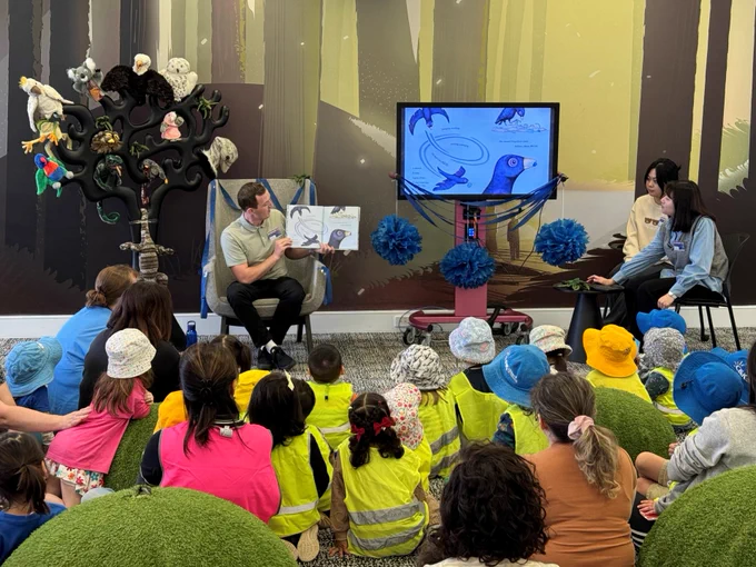 QUT Education students reading Bowerbird Blues to local kindergarten children.