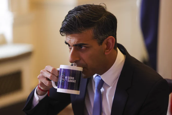 Rishi Sunak drinking from a mug with the caption AI Seoul Summit. Picture by Simon Dawson / 10 Downing Street.