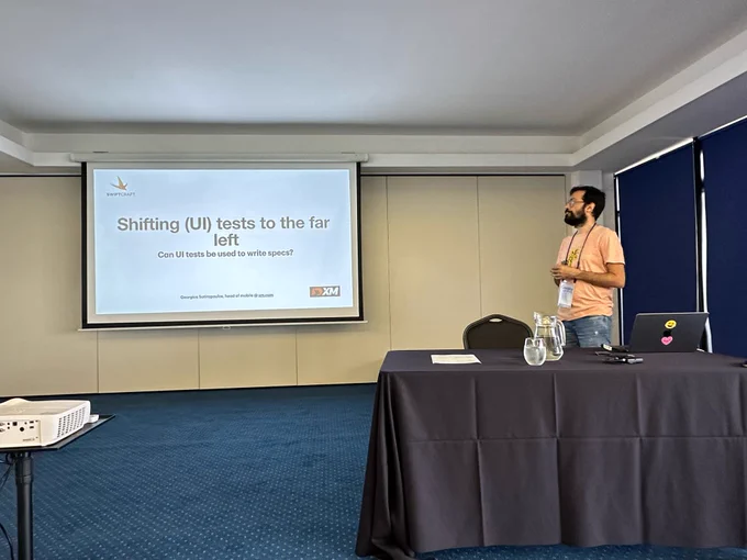 Georgious speaking with a slide that says “Shifting UI Tests to the far left