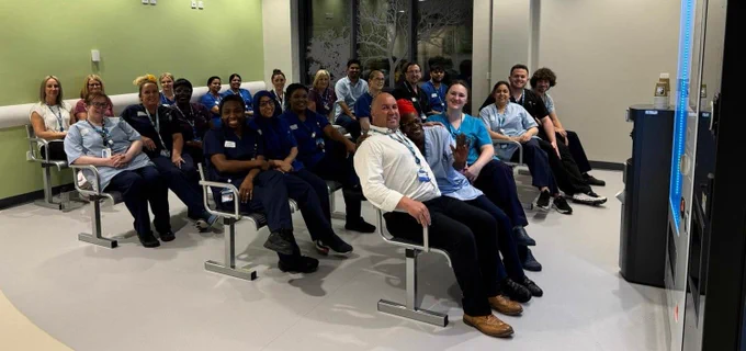 Colleagues sat in the waiting room chairs in our new A&E ahead of opening