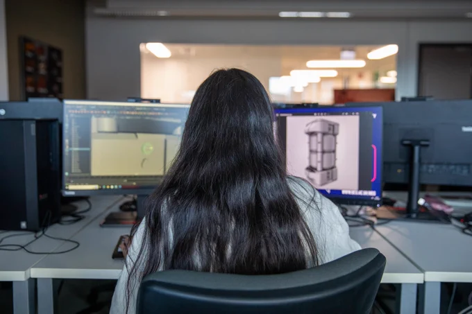 Person studying over two screens