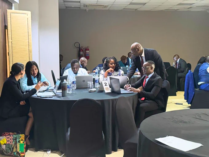 Zambia training course in financial investigations and asset recovery, students sit around a table working together