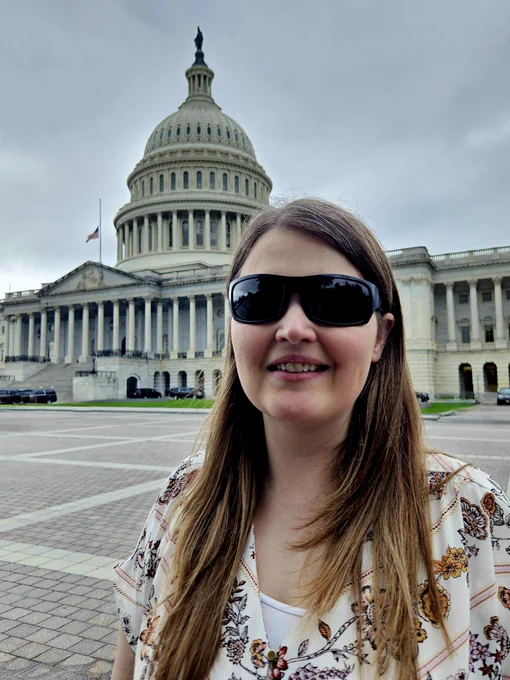 Marybeth smiling standing in front of the capitol.