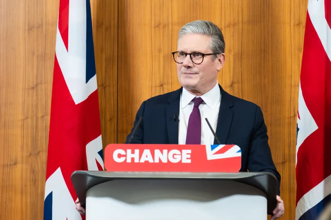 Keir Starmer standing behind a lectern giving a speech. Banner reads: change.