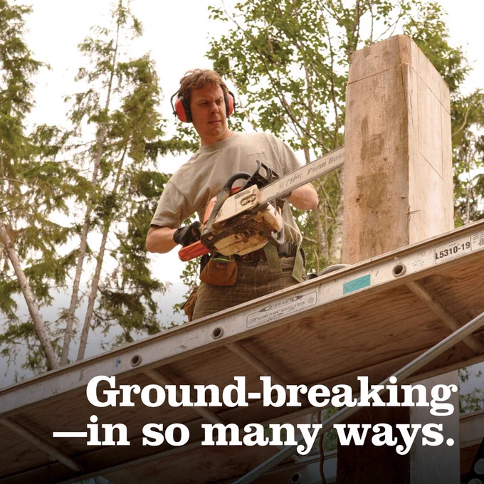 A man wearing hearing protection and holding a chainsaw stands on a wooden platform among trees, with the text "Ground-breaking - in so many ways." overlaid on the image.