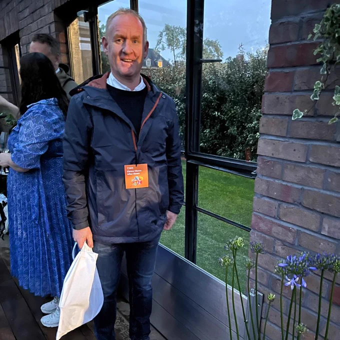 Gareth Boy from Watertight stood next to the flood barrier at the Flood Resilient Garden, Chelsea Flower Show