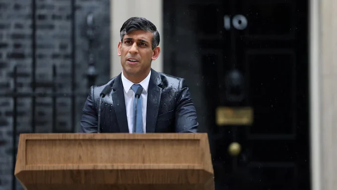 Photograph of Rishi Sunak drenched in rainwater outside No 10 Downing Street announcing a general election and the imminent destruction of the Tory party.