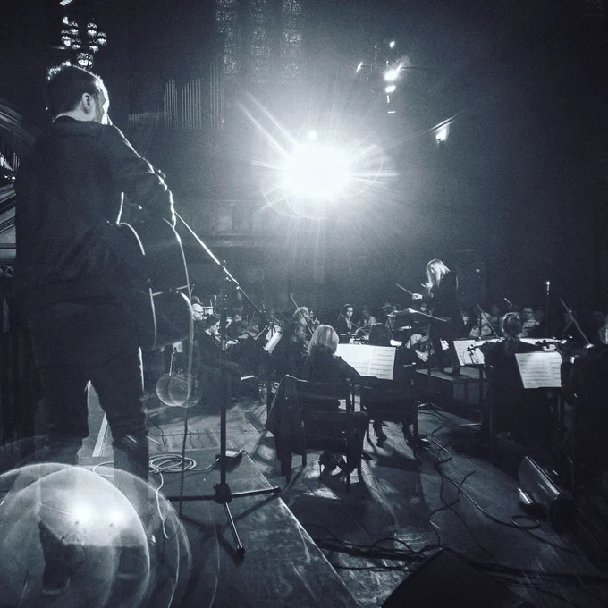 Yelpy playing live on stage with full orchestra