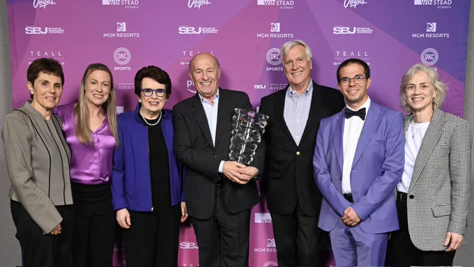 Ilana Kloss, Jana Hefford, Billie Jean King, Stan Kasten, Mark Walter, Royce Cohen, and Amy Scheer in front of the SBJ Sports Business Awards backdrop. Kasten is centered, holding the award.