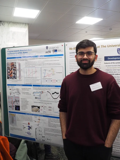Kamran stands next to his poster on progress towards strontium atom interferometry at RAL Space.
