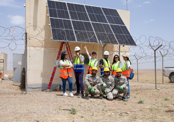  A diverse group of individuals smiling and posing for a photo together.