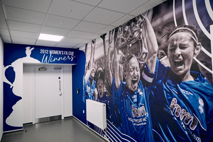 Wall design featuring the Women’s FA Cup win inside the Women’s Changing Room area.