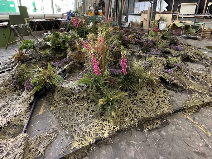 Green, pink and purple marshland is pictured in a workshop. 