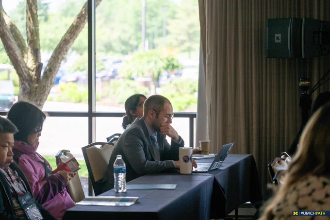 Dr. Ryan Landvater looked at his computer during the 2024 Pathology Informatics Summit.