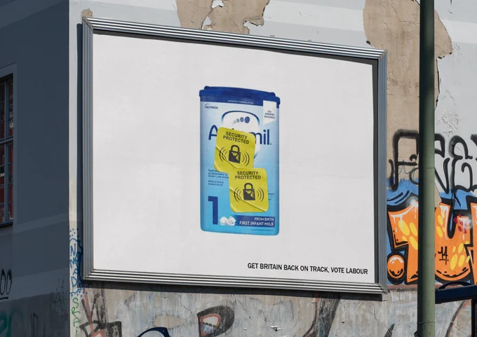 Image of infant formula with a yellow supermarket security tag - text below reads "Get Britain back on track, vote labour"