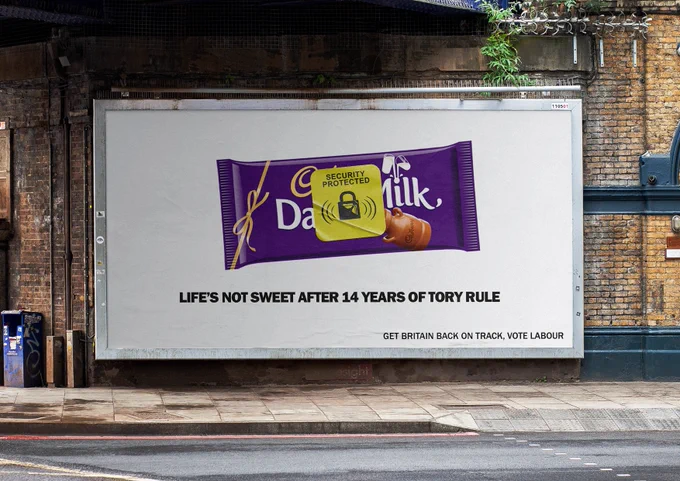 Image of a chocolate bar with a yellow supermarket security tag - text below reads "Life's not sweet after 14 years of Tory rule" and "Get Britain back on track, vote labour"
