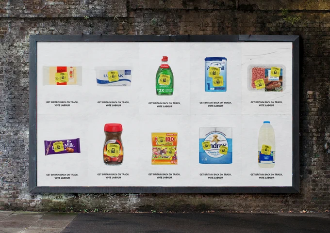 Image of various supermarket items (e.g. coffee, milk, toilet roll) with a yellow supermarket security tag - text below reads "Get Britain back on track, vote labour"