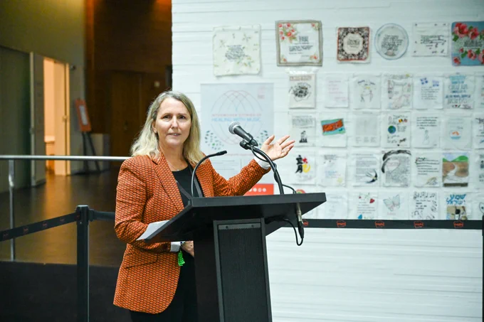 Diana Weymar speaking at a podium