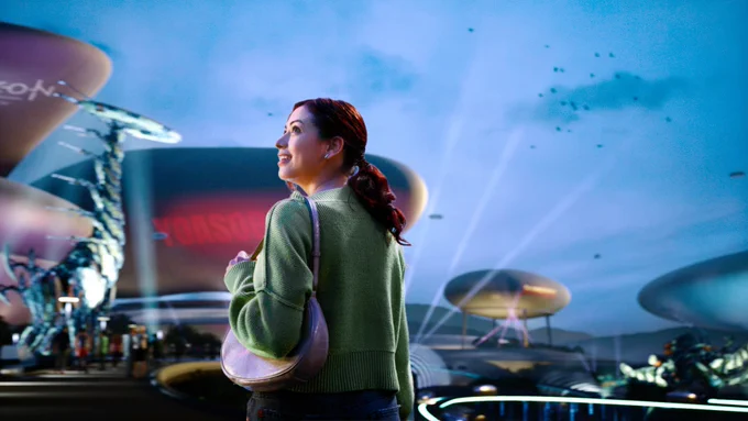 A woman looks around and smiles in a virtual entertainment space functioning as a representation of the physical world.