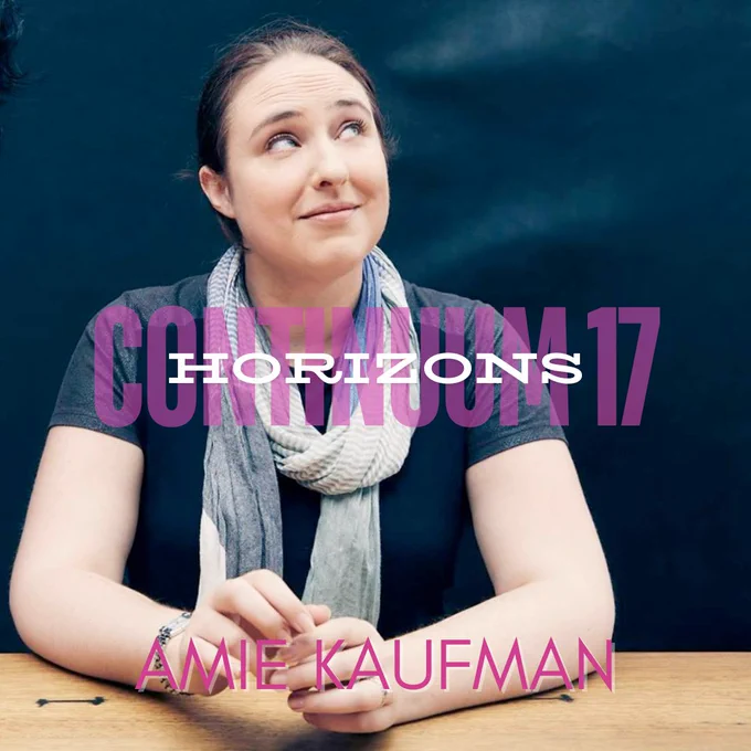 Amie Kaufman sitting at a table, looking up and to the right. In front of her are the words Continuum 17 Horizons, and her name.