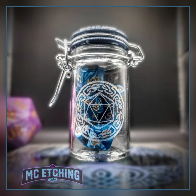 Small glass jar etched with a d20 dice design and filled with gaming dice