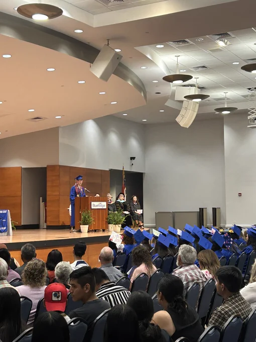 A student at the podium and a room full of people looking.