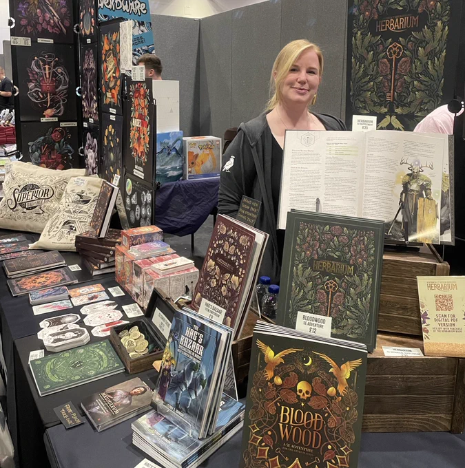 Fen standing at her gorgeous stall, full of books, prints, coins and notebooks.