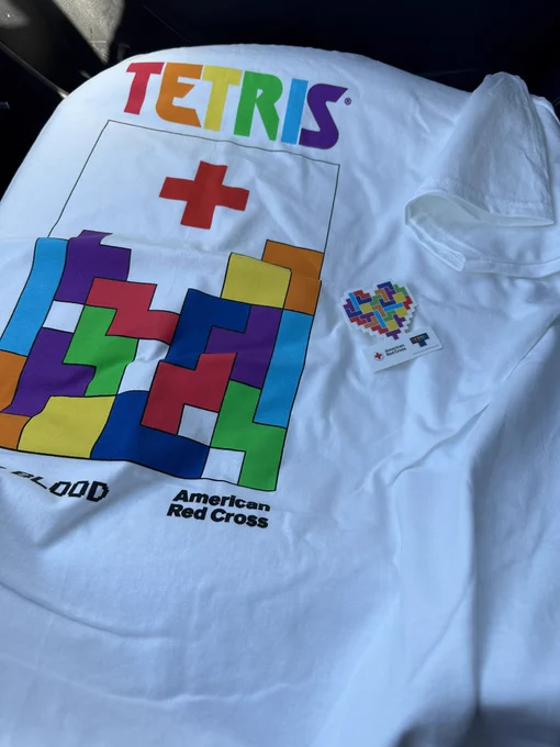 T-shirt from the American Red Cross with TETRIS pieces stacking up and the red cross falling into place.
