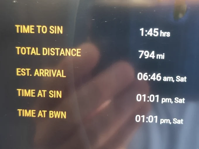 A flight progress screen showing "TIME TO SIN" as 1 hour and 45 minutes, and total distance as 794 miles.