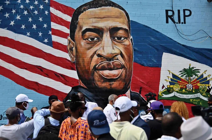 A mural dedicated to George Floyd featuring the American and Haitian flag.