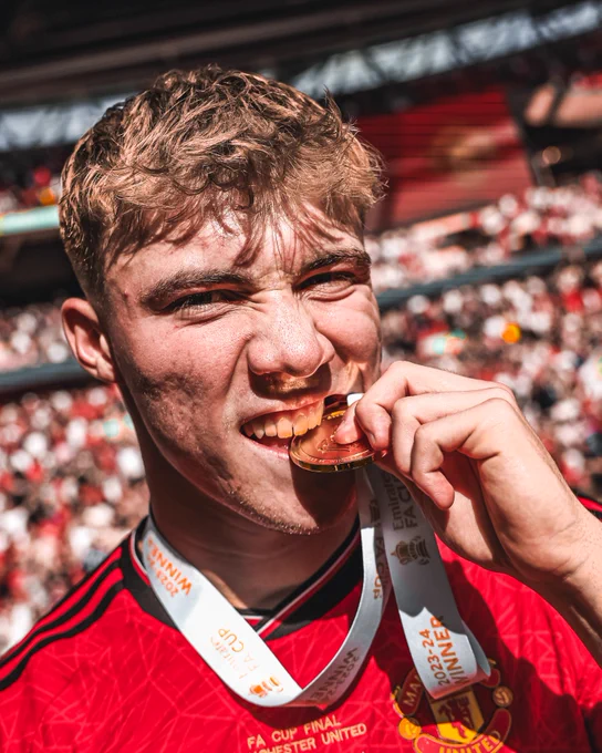 An image of Ramus Hojlund biting his Emirates FA Cup winners medal