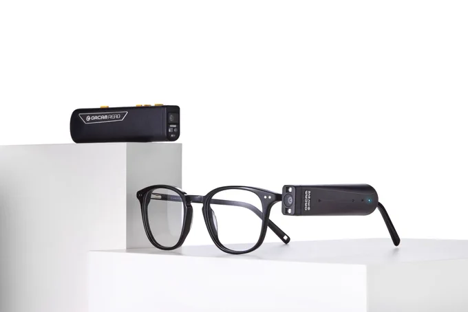 The OrCam Read 3 and OrCam MyEye devices showcased on sleek white platforms






