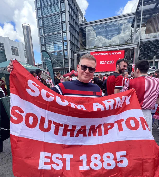 Josh holding his flag in the fan zone at Wembley