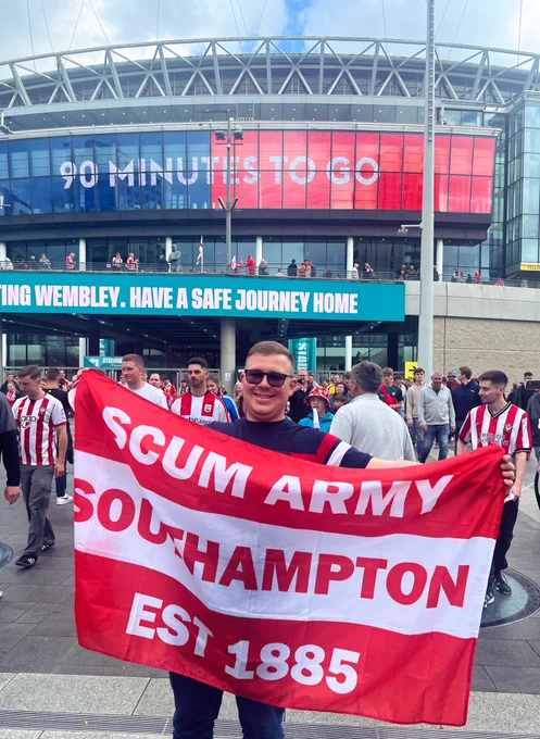 Josh holding his flag up outside Wembley after the win