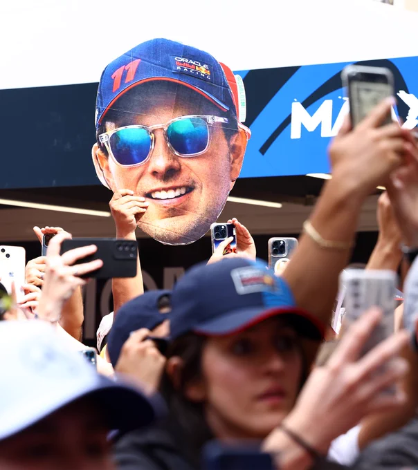 Fans hold up a cardboard cutout of Checo Perez at the Monaco GP.