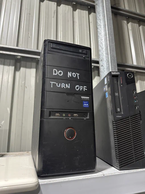 A pc tower case with “DO NOT TURN OFF” written on it