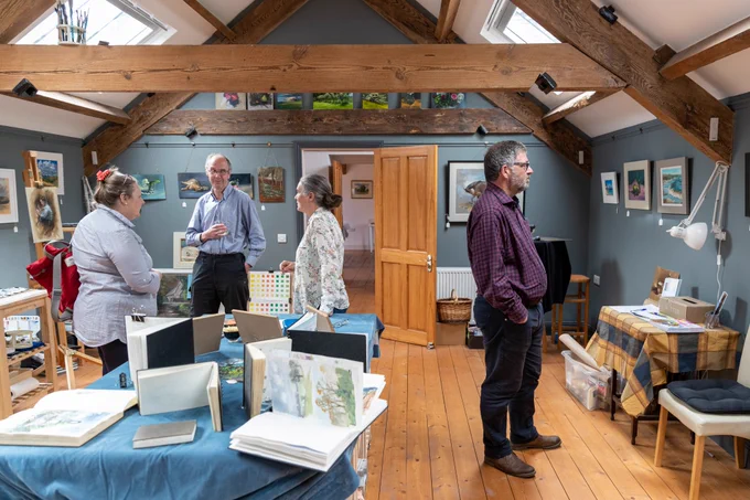 Visitors looking around an artist's studio