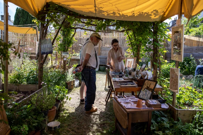 Visitors in an outdoor garden studio space