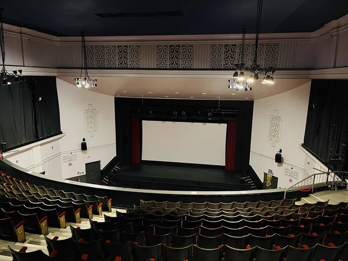 Photo of the interior of Barry Memo’s cinema, taken from a balcony.