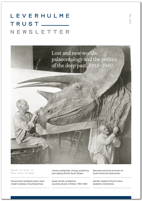 May Newsletter cover: black and white photograph of two older men working on a life-sized model of a Triceratops head.