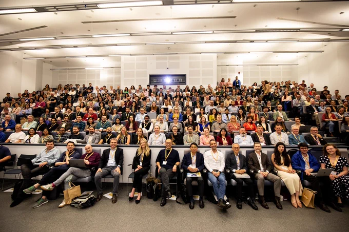 Group of people sat in a full lecture theatre