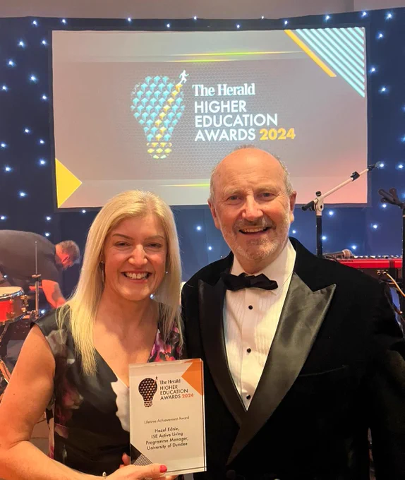 Hazel Ednie holds her Lifetime Achievement Award at the Herald HE Awards alongside Fred MacAulay