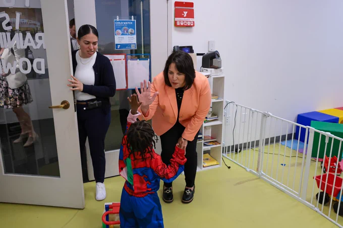 LG high-giving child in Spider-man costume.