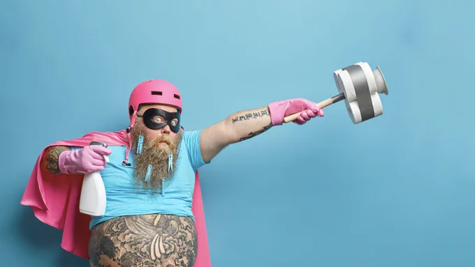 Un homme barbu surpris porte un costume de super héros